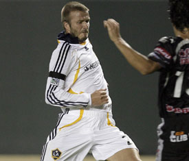 David Beckham goes in hard for the ball, before leaving the game with an injury.